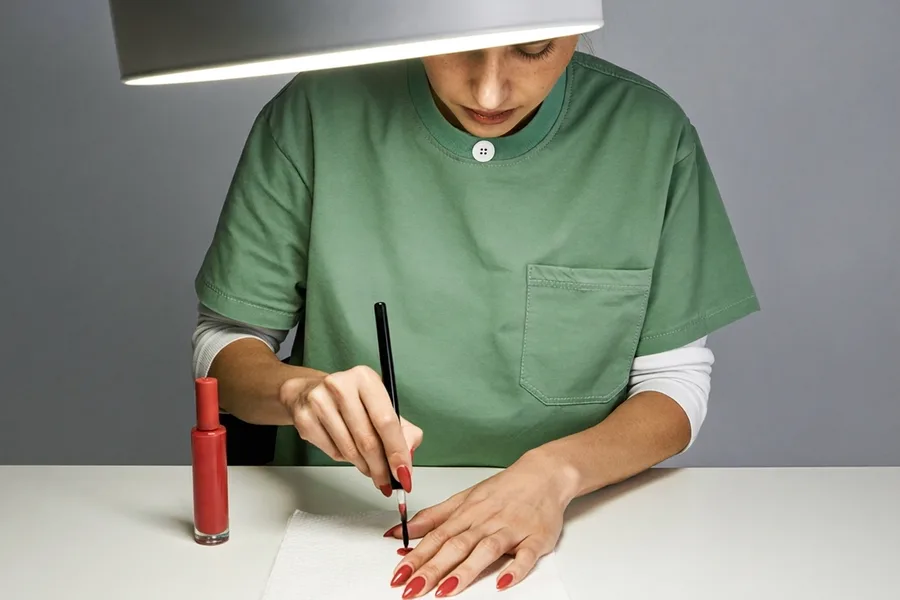 A nail technician at work in a small studio